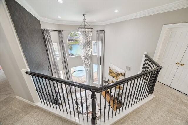 staircase with crown molding, carpet floors, recessed lighting, and a chandelier