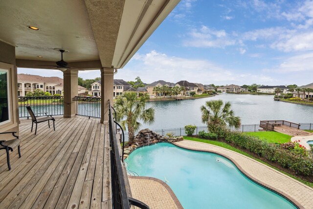 view of pool featuring a residential view, fence, a fenced in pool, and a water view