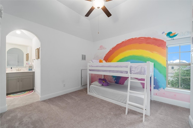 bedroom with carpet floors, arched walkways, visible vents, and vaulted ceiling