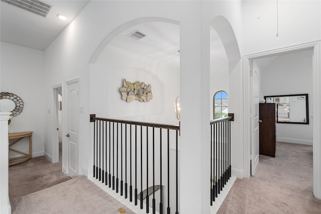 hallway with baseboards, an upstairs landing, carpet flooring, and visible vents