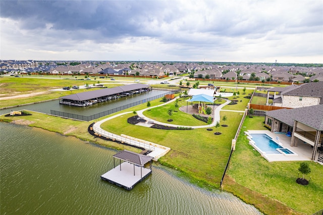 birds eye view of property featuring a water view and a residential view