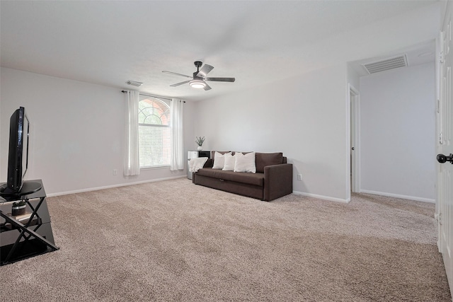 living room featuring visible vents, a ceiling fan, baseboards, and carpet flooring