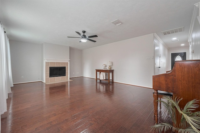 unfurnished living room with baseboards, ceiling fan, wood finished floors, and visible vents
