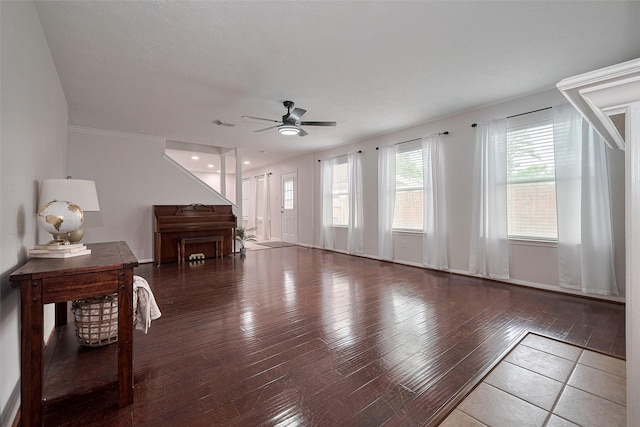 living area with a ceiling fan, hardwood / wood-style flooring, and visible vents