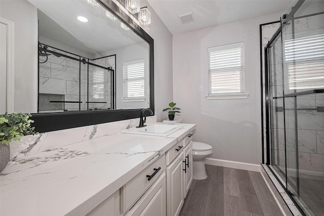 full bathroom with visible vents, wood finished floors, toilet, baseboards, and a stall shower