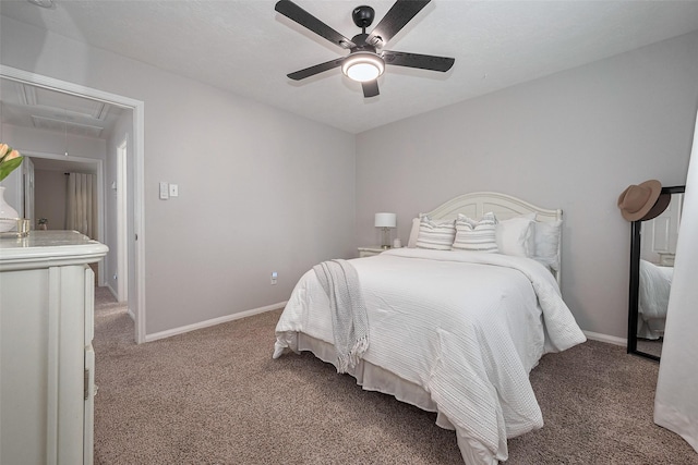 bedroom with carpet flooring, a ceiling fan, baseboards, and attic access