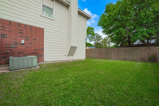 view of yard featuring a fenced backyard and central air condition unit