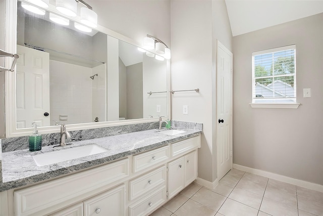 14010 Lakewood Crossing Blvd, Houston, TX 77070 - bathroom with a sink, baseboards, vaulted ceiling, and double vanity