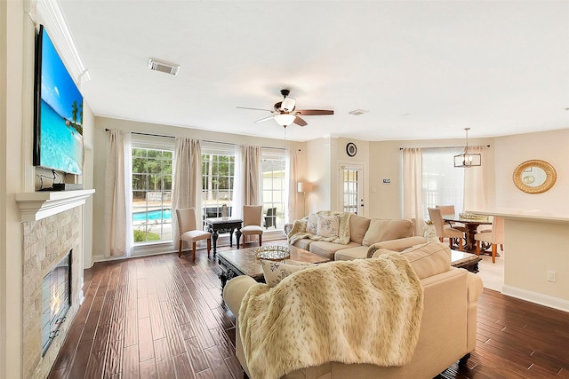 14010 Lakewood Crossing Blvd, Houston, TX 77070 - living area featuring visible vents, dark wood-style flooring, a fireplace, baseboards, and a ceiling fan