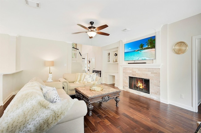 14010 Lakewood Crossing Blvd, Houston, TX 77070 - living room with a glass covered fireplace, a ceiling fan, baseboards, wood finished floors, and visible vents