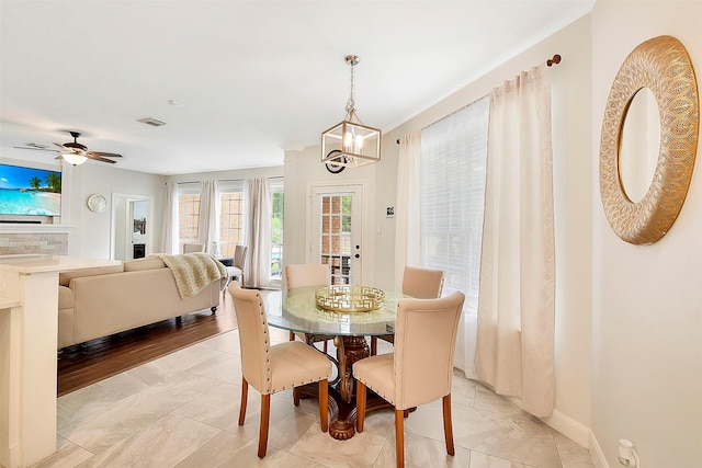 14010 Lakewood Crossing Blvd, Houston, TX 77070 - dining space featuring visible vents, baseboards, and ceiling fan with notable chandelier