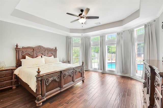 14010 Lakewood Crossing Blvd, Houston, TX 77070 - bedroom featuring visible vents, a raised ceiling, dark wood-style flooring, and access to exterior