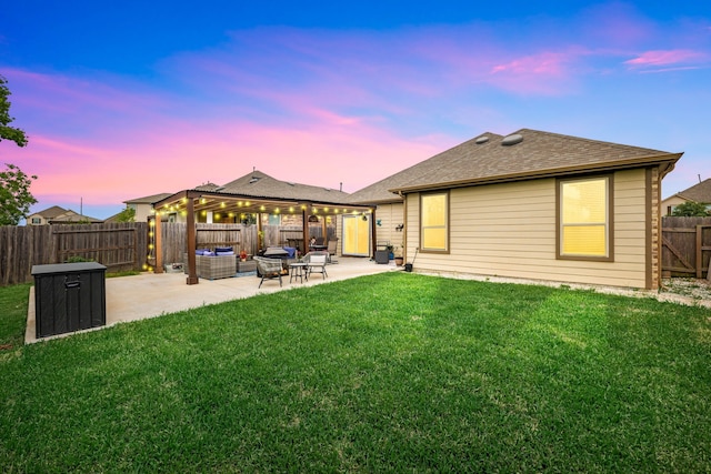 back of house at dusk with a lawn, a fenced backyard, a patio area, and roof with shingles