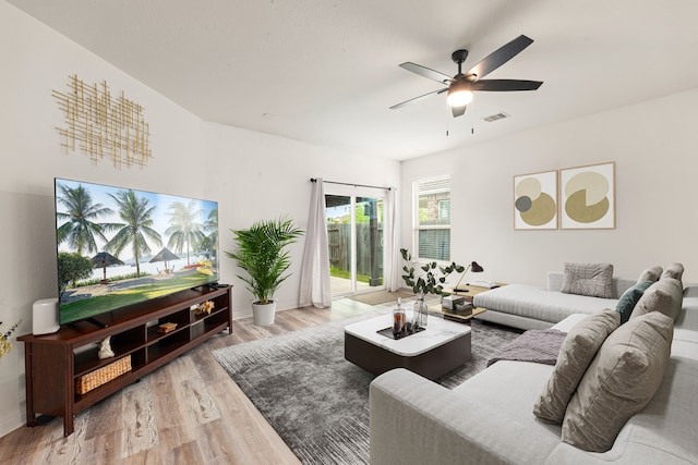 living room with visible vents, baseboards, ceiling fan, and wood finished floors