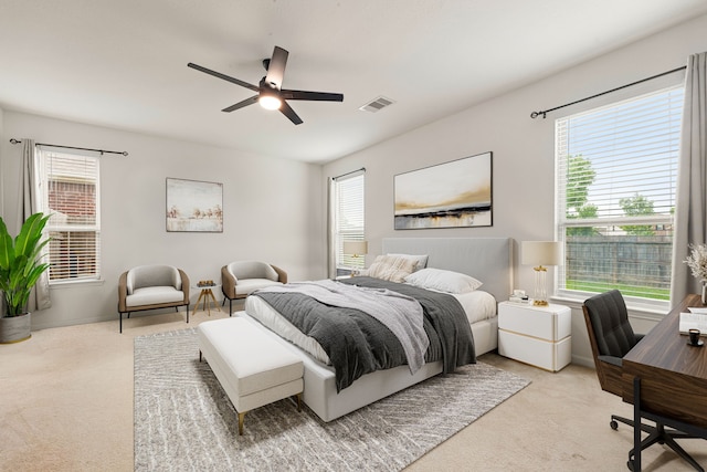 carpeted bedroom with visible vents, ceiling fan, and multiple windows