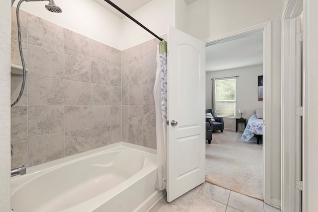 ensuite bathroom with tile patterned floors, shower / bath combo with shower curtain, and ensuite bath
