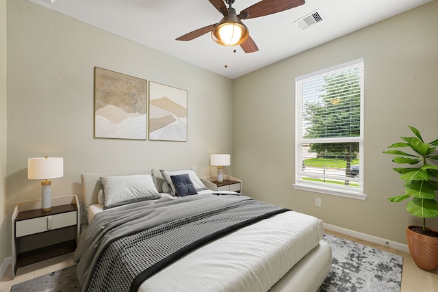 bedroom featuring visible vents, carpet flooring, baseboards, and ceiling fan