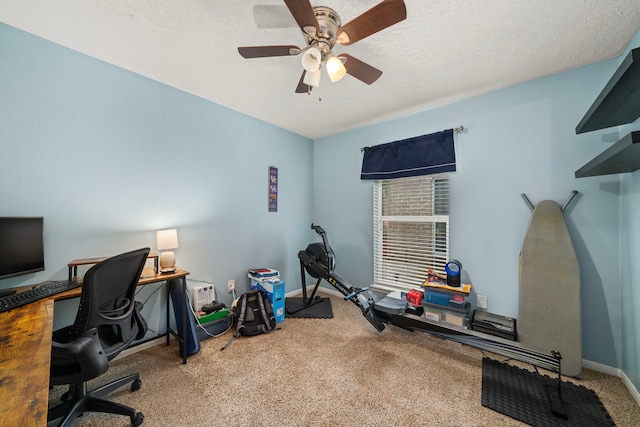 office area featuring a ceiling fan, baseboards, carpet, and a textured ceiling