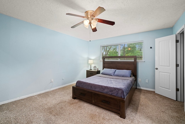 bedroom featuring carpet flooring, a textured ceiling, and baseboards
