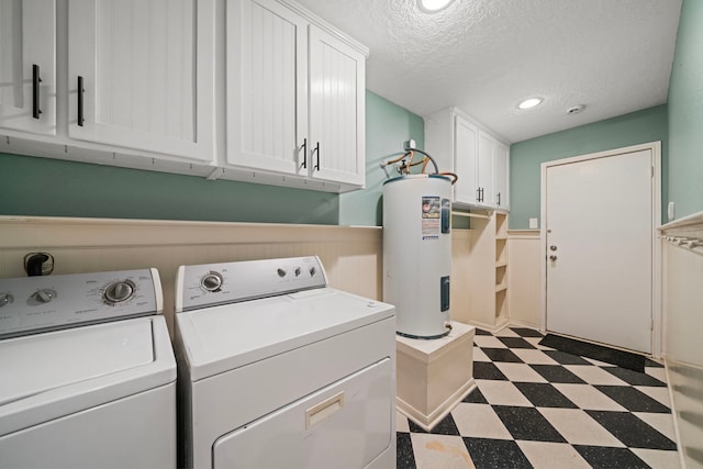 laundry room featuring cabinet space, a textured ceiling, tile patterned floors, water heater, and washer and clothes dryer