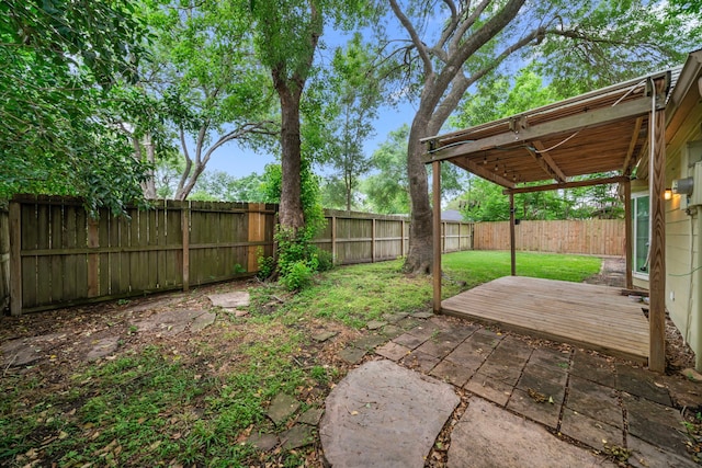 view of yard featuring a fenced backyard and a wooden deck