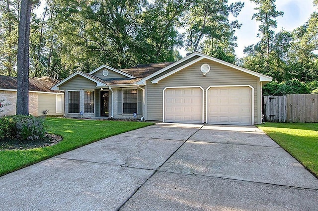ranch-style home featuring fence, an attached garage, driveway, and a front lawn