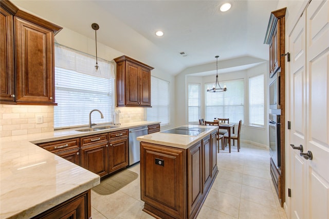 kitchen featuring backsplash, decorative light fixtures, a sink, stainless steel appliances, and an island with sink