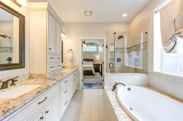 ensuite bathroom featuring a sink, ceiling fan, a stall shower, and connected bathroom