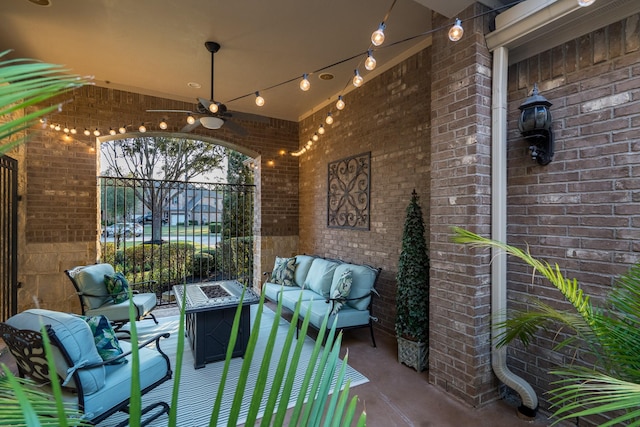 view of patio / terrace featuring fence, a ceiling fan, and an outdoor living space with a fire pit