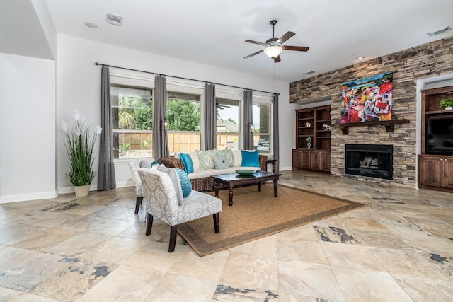 living area featuring baseboards, a ceiling fan, and visible vents