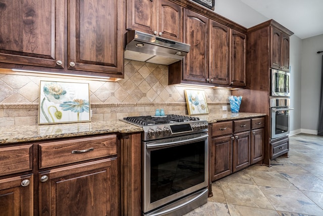 kitchen with light stone counters, appliances with stainless steel finishes, under cabinet range hood, and dark brown cabinetry