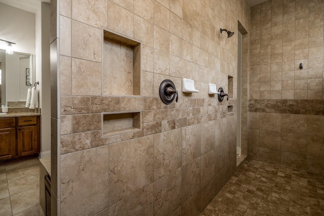 full bath featuring a walk in shower and vanity