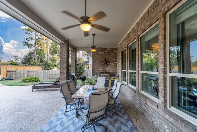 view of patio / terrace featuring fence, outdoor dining area, and ceiling fan