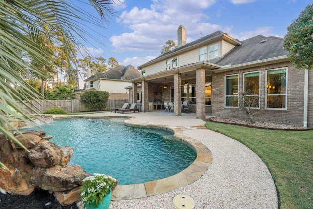 view of swimming pool featuring fence, a fenced in pool, a patio, and a lawn