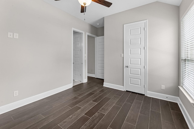 unfurnished bedroom featuring baseboards, dark wood finished floors, and ceiling fan