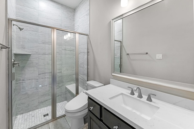 bathroom featuring vanity, toilet, marble finish floor, and a stall shower