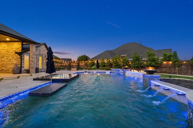 view of swimming pool featuring a patio, a pool with connected hot tub, and a fenced backyard