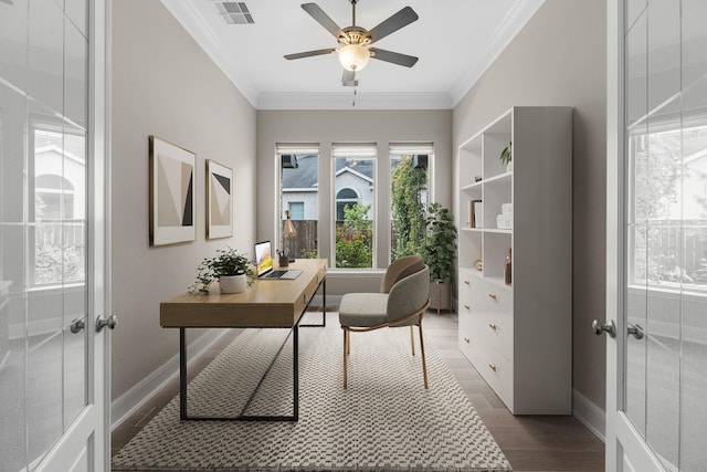 office with crown molding, a ceiling fan, baseboards, and visible vents