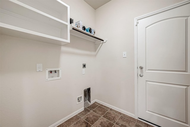 clothes washing area with dark tile patterned floors, hookup for an electric dryer, laundry area, baseboards, and hookup for a washing machine