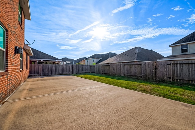 view of patio / terrace featuring a fenced backyard and a residential view