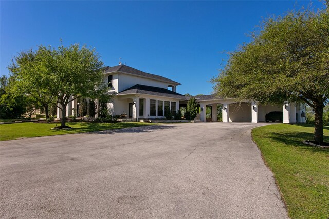 7576 River Ridge Drive, College Station, TX 77845 - view of front of property featuring a garage, a front lawn, aphalt driveway, and stucco siding