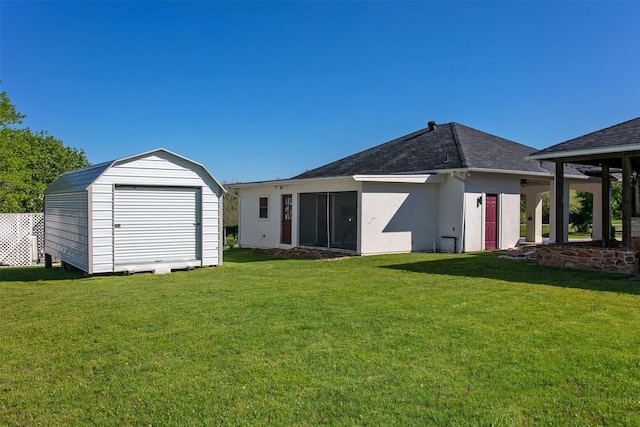 7576 River Ridge Drive, College Station, TX 77845 - rear view of house featuring roof with shingles, a storage unit, and a lawn