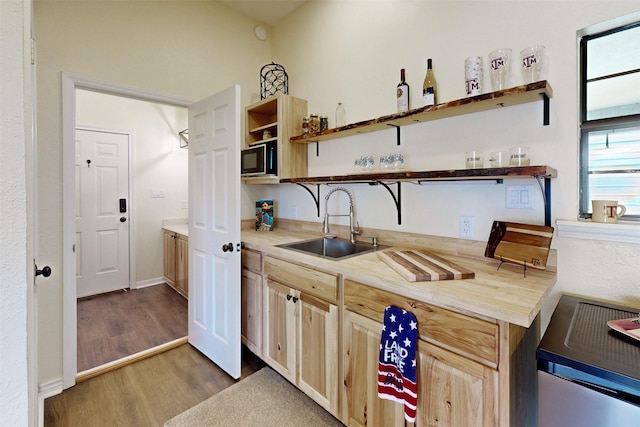 7576 River Ridge Drive, College Station, TX 77845 - kitchen featuring open shelves, a sink, light brown cabinets, light countertops, and wood finished floors