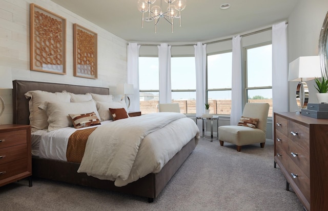 bedroom with a notable chandelier and light carpet