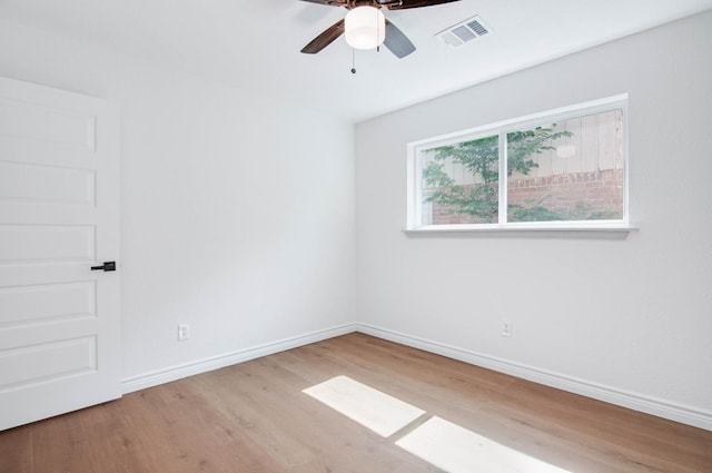 empty room with visible vents, baseboards, ceiling fan, and wood finished floors