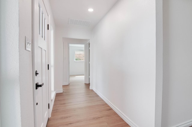 hallway with visible vents, recessed lighting, light wood finished floors, and baseboards