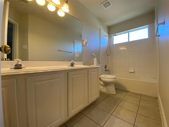 bathroom with shower / bath combination, toilet, visible vents, a sink, and tile patterned flooring