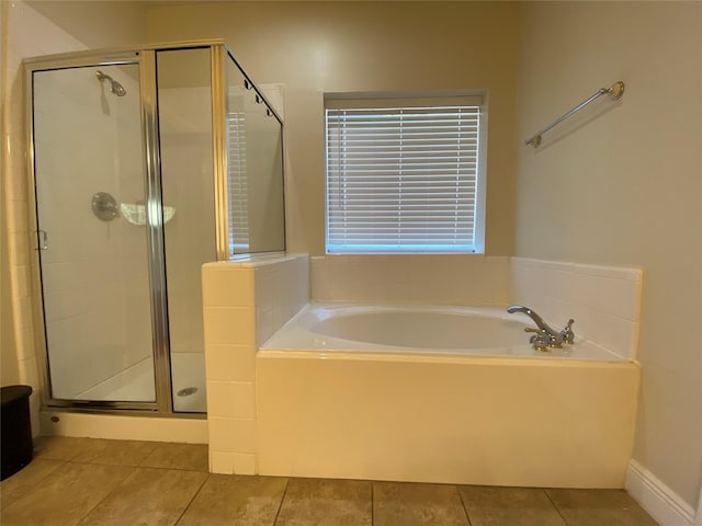 bathroom featuring a stall shower, a bath, and tile patterned floors