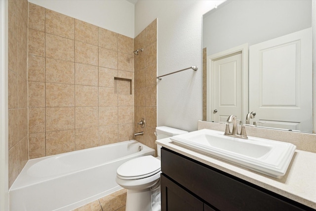 bathroom with bathing tub / shower combination, a textured wall, vanity, and toilet