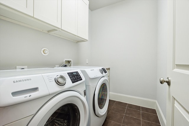 clothes washing area featuring separate washer and dryer, cabinet space, baseboards, and dark tile patterned floors